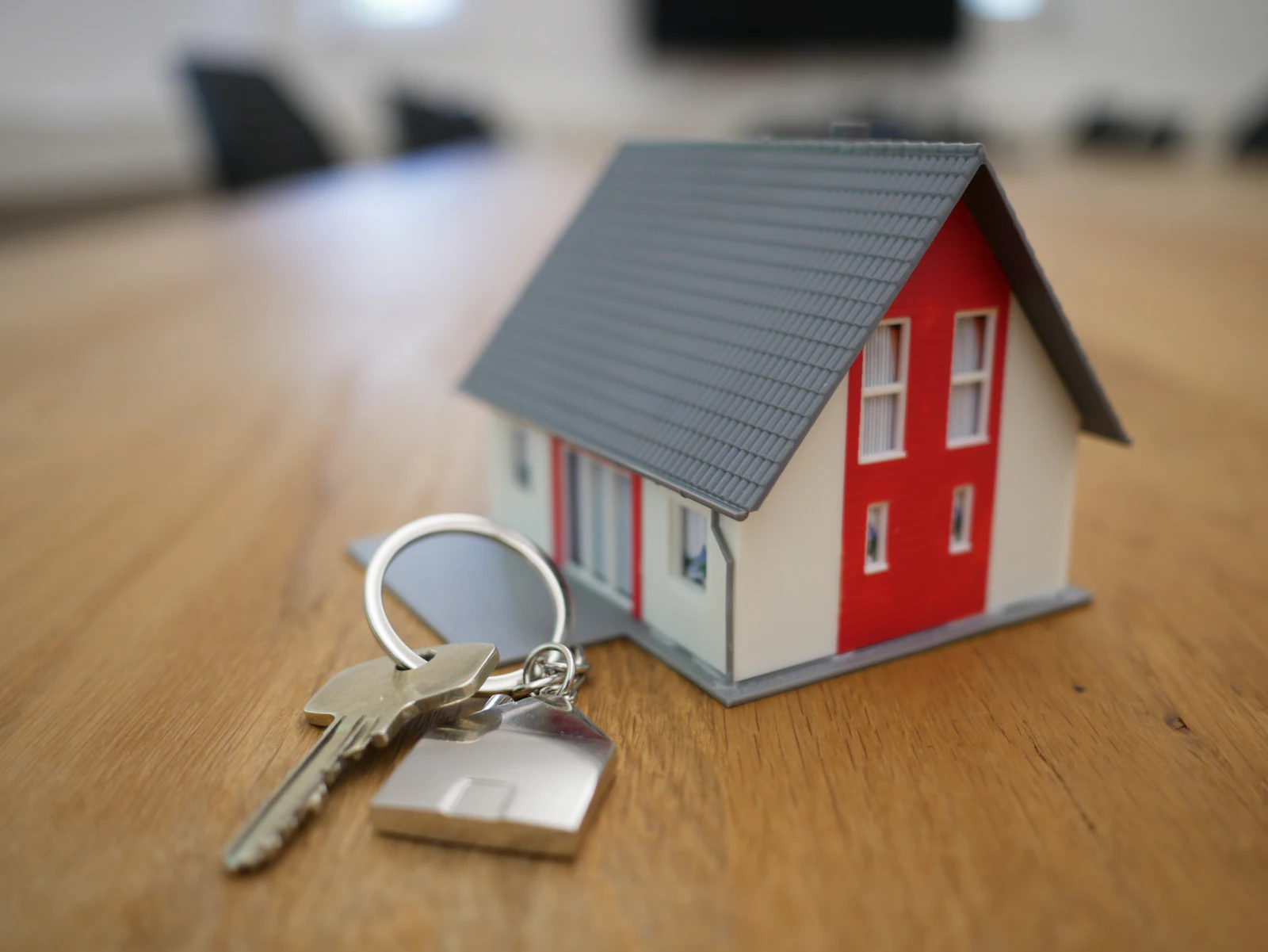 House keys on a keyring with a small house charm